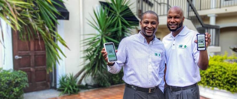 Junk Shot founders holding the Junk Shot app
