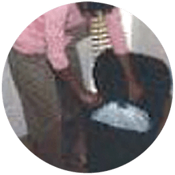 Resident placing bagged trash in the provided container